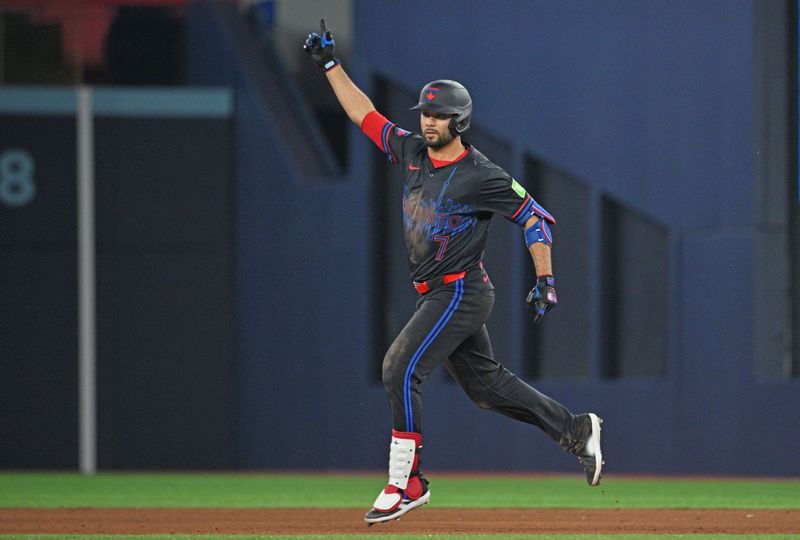 Jun 5, 2024; Toronto, Ontario, CAN;   Toronto Blue Jays third baseman Isiah Kiner-Falefa (7) celebrates after hitting a walk off RBI single against the Baltimore Orioles in the ninth inning at Rogers Centre. Mandatory Credit: Dan Hamilton-USA TODAY Sports  