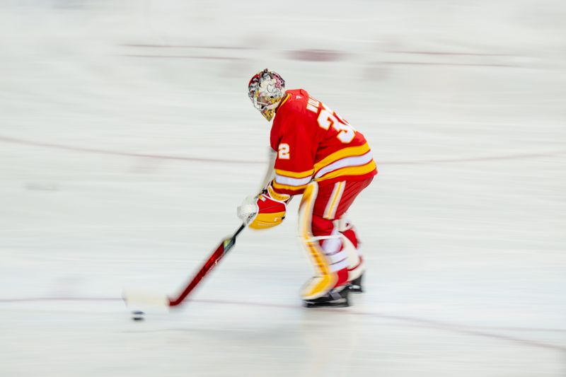 Oct 20, 2025; Calgary, Alberta, CAN; Calgary Flames goaltender Dustin Wolf (32) warms up before a game against the Winnipeg Jets at Scotiabank Saddledome. Mandatory Credit: Brett Holmes-Imagn Images