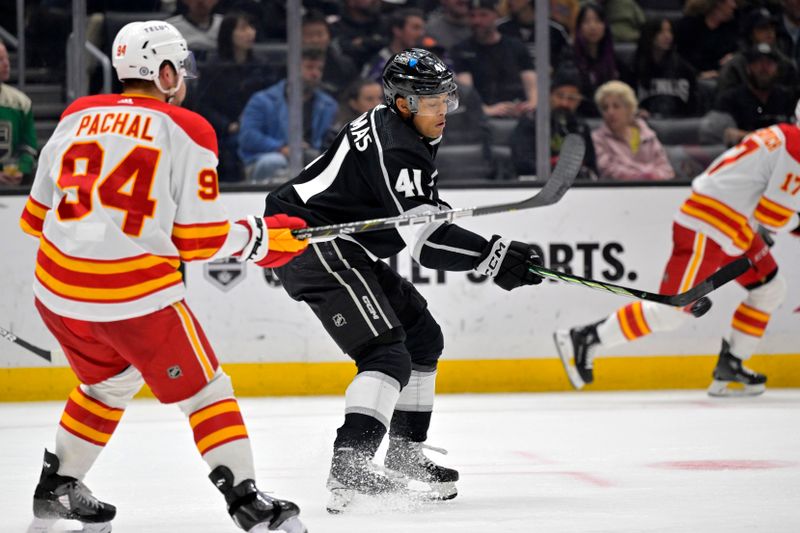 Apr 11, 2024; Los Angeles, California, USA; Los Angeles Kings center Akil Thomas (41) gets the puck past Calgary Flames defenseman Brayden Pachal (94) for a goal in the second period at Crypto.com Arena. Mandatory Credit: Jayne Kamin-Oncea-USA TODAY Sports