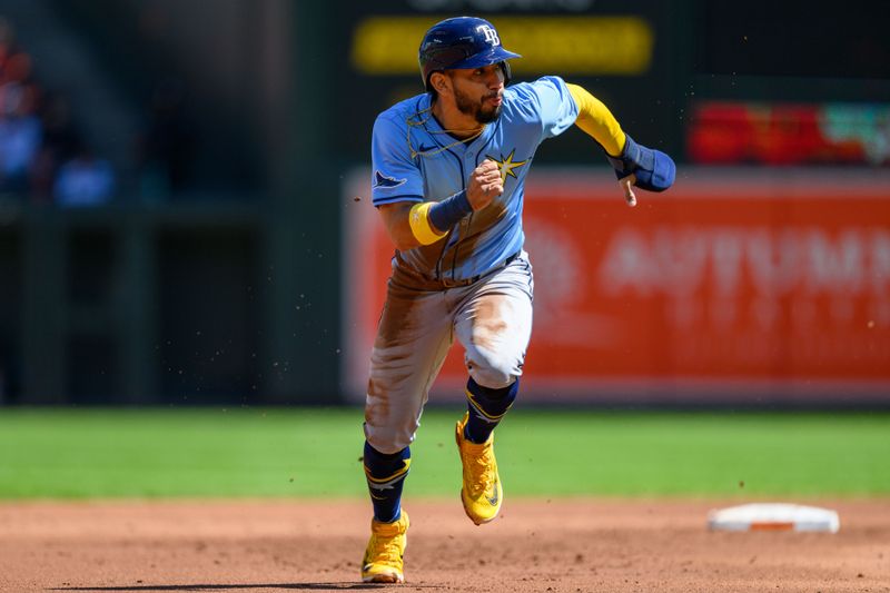 Sep 8, 2024; Baltimore, Maryland, USA; Tampa Bay Rays shortstop José Caballero (7) steals third base during the second inning against the Baltimore Orioles at Oriole Park at Camden Yards. Mandatory Credit: Reggie Hildred-Imagn Images