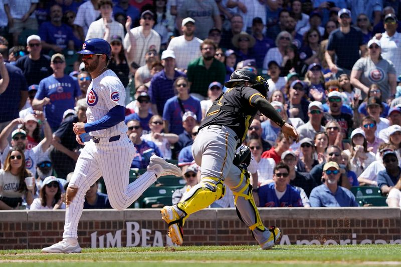 May 19, 2024; Chicago, Illinois, USA; Chicago Cubs shortstop Miles Mastrobuoni (20) scores as Pittsburgh Pirates catcher Yasmani Grandal (6) takes a late throw during the third inning at Wrigley Field. Mandatory Credit: David Banks-USA TODAY Sports