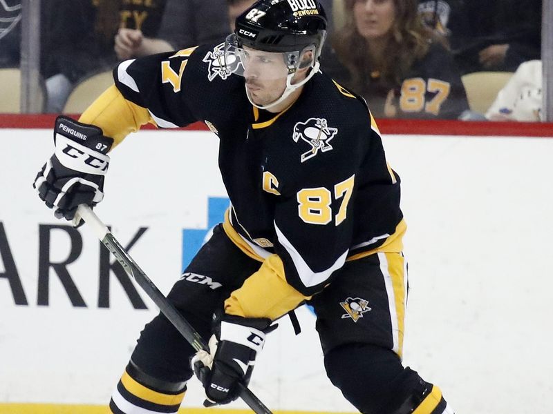 Feb 23, 2023; Pittsburgh, Pennsylvania, USA;  Pittsburgh Penguins center Sidney Crosby (87) handles the puck against the Edmonton Oilers during the second period at PPG Paints Arena. Mandatory Credit: Charles LeClaire-USA TODAY Sports