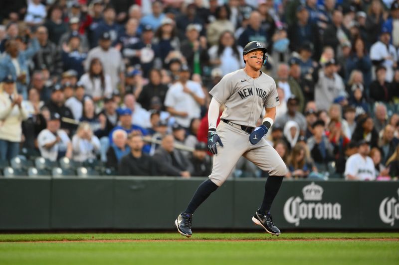 May 12, 2025; Seattle, Washington, USA; New York Yankees right fielder Aaron Judge (99) stops running at third base during the fifth inning against the Seattle Mariners at T-Mobile Park. Mandatory Credit: Steven Bisig-Imagn Images