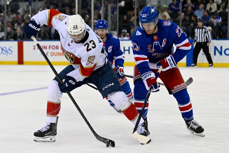 Mar 29, 2026; New York, New York, USA; Florida Panthers center Carter Verhaeghe (23) and New York Rangers defenseman Adam Fox (23) battle for the puck during the second period at Madison Square Garden. Mandatory Credit: Dennis Schneidler-Imagn Images