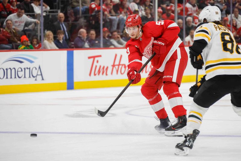 Nov 23, 2024; Detroit, Michigan, USA; Detroit Red Wings defenseman Moritz Seider (53) shoots the puck during the second period of the game against the Boston Bruins at Little Caesars Arena. Mandatory Credit: Brian Bradshaw Sevald-Imagn Images