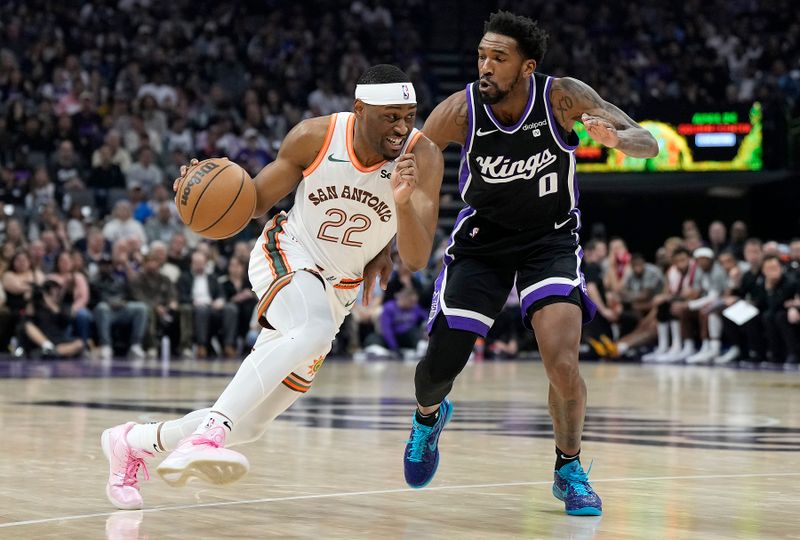 SACRAMENTO, CALIFORNIA - MARCH 07: Malaki Branham #22 of the San Antonio Spurs drives to the basket on Malik Monk #0 of the Sacramento Kings during the first half at Golden 1 Center on March 07, 2024 in Sacramento, California. NOTE TO USER: User expressly acknowledges and agrees that, by downloading and or using this photograph, User is consenting to the terms and conditions of the Getty Images License Agreement. (Photo by Thearon W. Henderson/Getty Images)