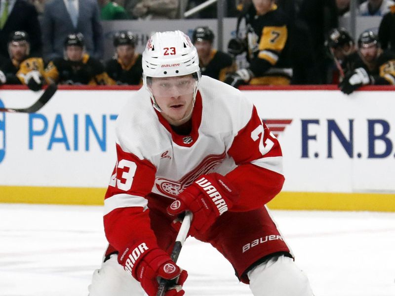 Mar 17, 2024; Pittsburgh, Pennsylvania, USA;  Detroit Red Wings left wing Lucas Raymond (23) skates with the puck against the Pittsburgh Penguins during the second period at PPG Paints Arena. Mandatory Credit: Charles LeClaire-USA TODAY Sports