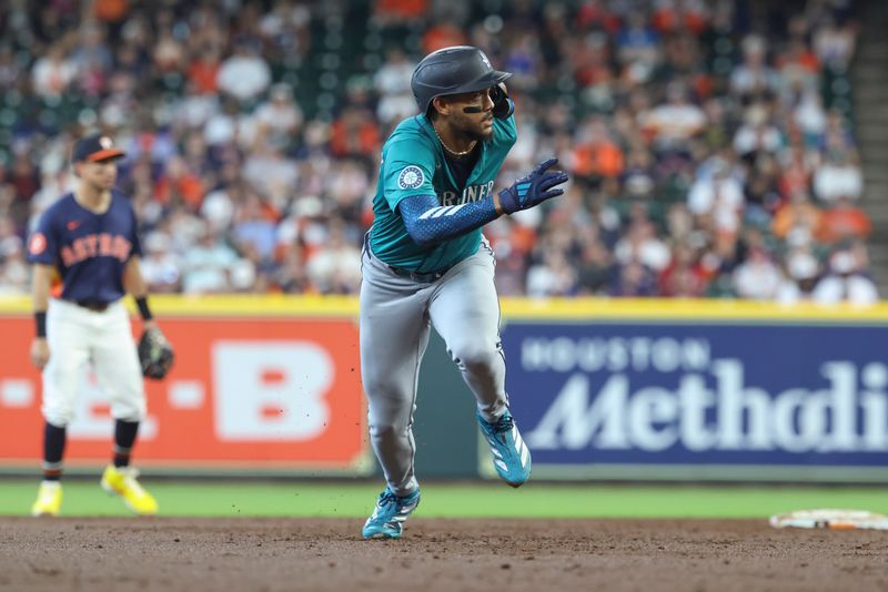 May 25, 2025; Houston, Texas, USA; Seattle Mariners center fielder Julio Rodriguez (44) breaks for third base during the third inning against the Houston Astros at Daikin Park. Mandatory Credit: Troy Taormina-Imagn Images