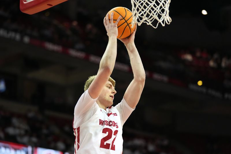 Feb 22, 2023; Madison, Wisconsin, USA; Wisconsin Badgers forward Steven Crowl (22) rebounds the ball during the first half against the Iowa Hawkeyes at the Kohl Center. Mandatory Credit: Kayla Wolf-USA TODAY Sports