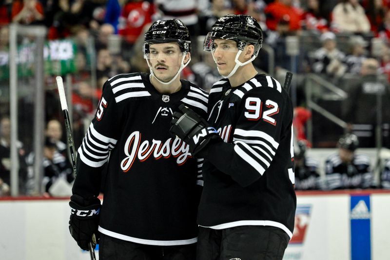 Apr 7, 2024; Newark, New Jersey, USA; New Jersey Devils center Shane Bowers (15) and New Jersey Devils left wing Tomas Nosek (92) talk during a break in the action in the second period against the Nashville Predators at Prudential Center. Mandatory Credit: John Jones-USA TODAY Sports