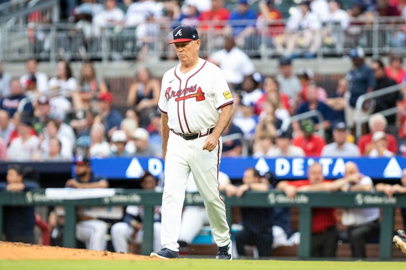 Sep 29, 2024; Cumberland, Georgia, USA; Atlanta Braves manager Brian Snitker (43) walks to the mound in the game against Kansas City Royals during the ninth inning at Truist Park. Mandatory Credit: Jordan Godfree-Imagn Images