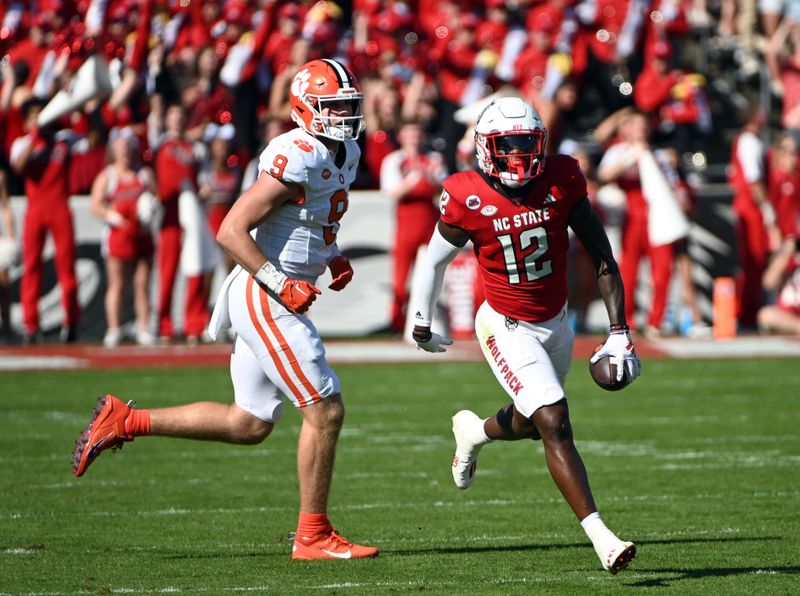 Oct 28, 2023; Raleigh, North Carolina, USA; North Carolina State Wolfpack safety Devan Boykin (12) reacts after intercepting a pass during the first half against the Clemson Tigers at Carter-Finley Stadium. Mandatory Credit: Rob Kinnan-USA TODAY Sports