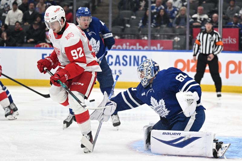 Jan 21, 2026; Toronto, Ontario, CAN; Toronto Maple Leafs goalie Joseph Woll (60) makes a save on a shot screened by Detroit Red Wings forward Marco Kasper (92) in the second period at Scotiabank Arena. Mandatory Credit: Dan Hamilton-Imagn Images