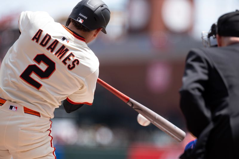 Apr 26, 2025; San Francisco, California, USA; San Francisco Giants shortstop Willy Adames (2) grounds into a double play against the Texas Rangers during the first inning at Oracle Park. Mandatory Credit: D. Ross Cameron-Imagn Images