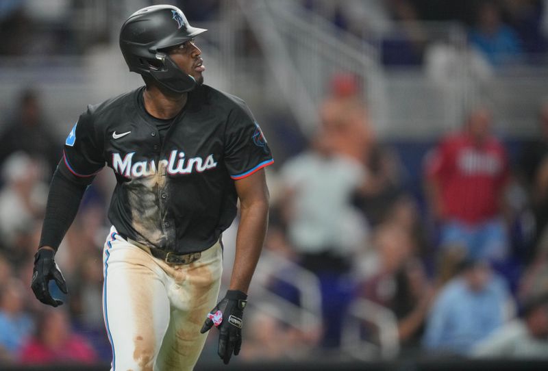 May 31, 2024; Miami, Florida, USA;  Miami Marlins right fielder Jesús Sánchez (12) watches his three-run home run in the seventh inning against the Texas Rangers at loanDepot Park. Mandatory Credit: Jim Rassol-USA TODAY Sports