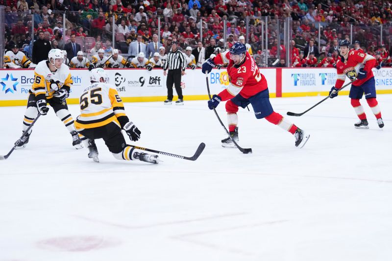 Jan 3, 2025; Sunrise, Florida, USA; Florida Panthers center Carter Verhaeghe (23) shoots the puck against Pittsburgh Penguins center Noel Acciari (55) during the third period at Amerant Bank Arena. Mandatory Credit: Rich Storry-Imagn Images