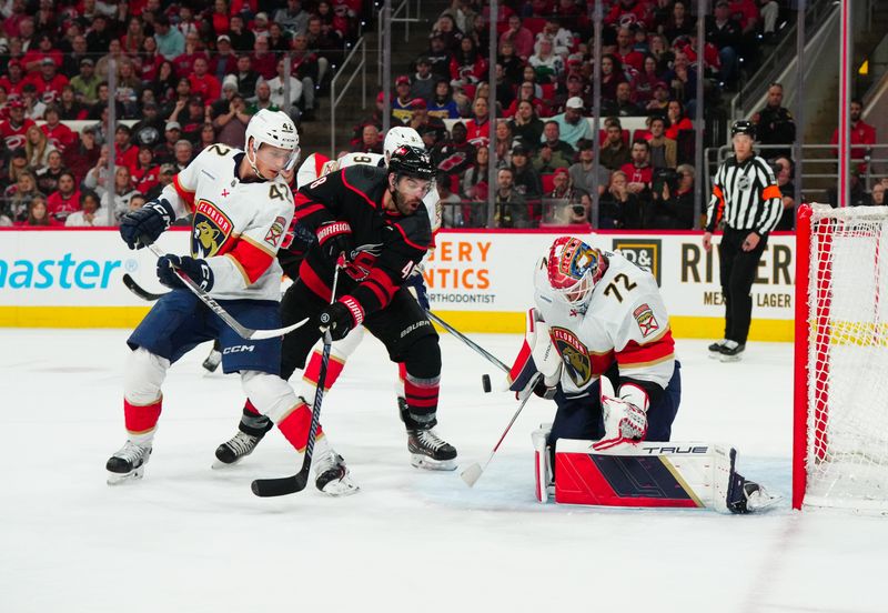 Mar 14, 2024; Raleigh, North Carolina, USA; Carolina Hurricanes left wing Jordan Martinook (48) shot attempt is stopped by Florida Panthers goaltender Sergei Bobrovsky (72) and defenseman Gustav Forsling (42) during the first period at PNC Arena. Mandatory Credit: James Guillory-USA TODAY Sports