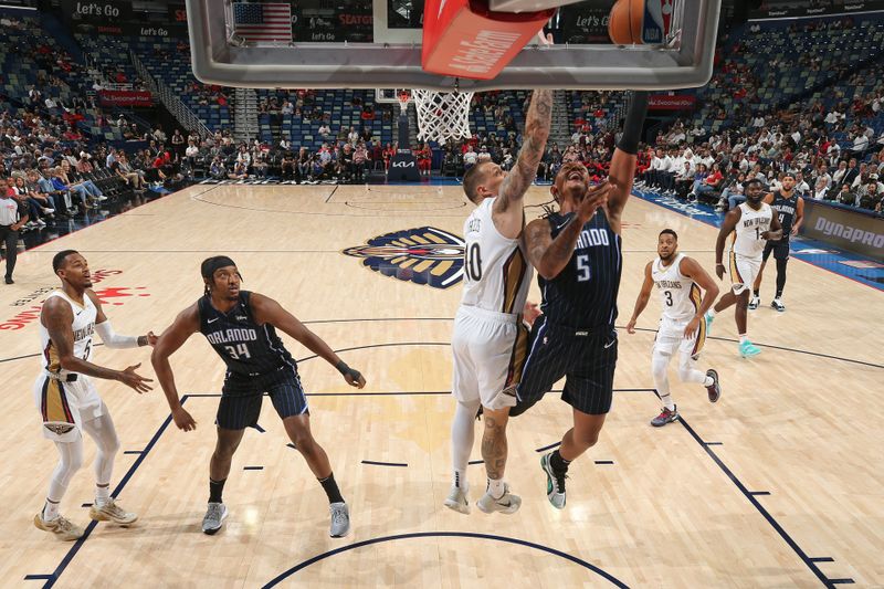 NEW ORLEANS, LA - OCTOBER 7: Paolo Banchero #5 of the Orlando Magic drives to the basket during the game against the New Orleans Pelicans on October 7, 2024 at the Smoothie King Center in New Orleans, Louisiana. NOTE TO USER: User expressly acknowledges and agrees that, by downloading and or using this Photograph, user is consenting to the terms and conditions of the Getty Images License Agreement. Mandatory Copyright Notice: Copyright 2024 NBAE (Photo by Layne Murdoch Jr./NBAE via Getty Images)