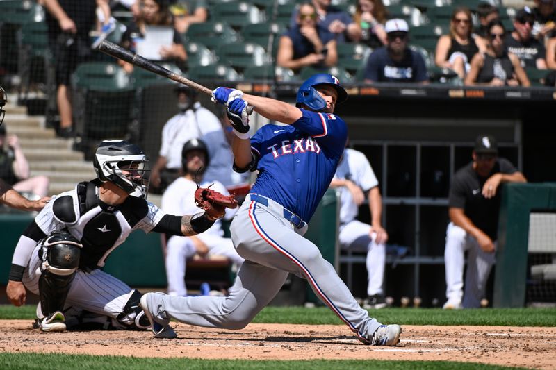 Aug 29, 2024; Chicago, Illinois, USA;  Texas Rangers shortstop Corey Seager (5) hits a solo home run against the Chicago White Sox during the fourth inning at Guaranteed Rate Field. Mandatory Credit: Matt Marton-USA TODAY Sports