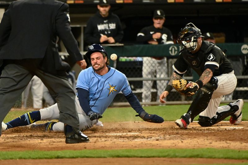 Apr 29, 2023; Chicago, Illinois, USA; Tampa Bay Rays right fielder Josh Lowe (15) scores past Chicago White Sox catcher Yasmani Grandal (24) during the seventh inning at Guaranteed Rate Field. Mandatory Credit: Matt Marton-USA TODAY Sports