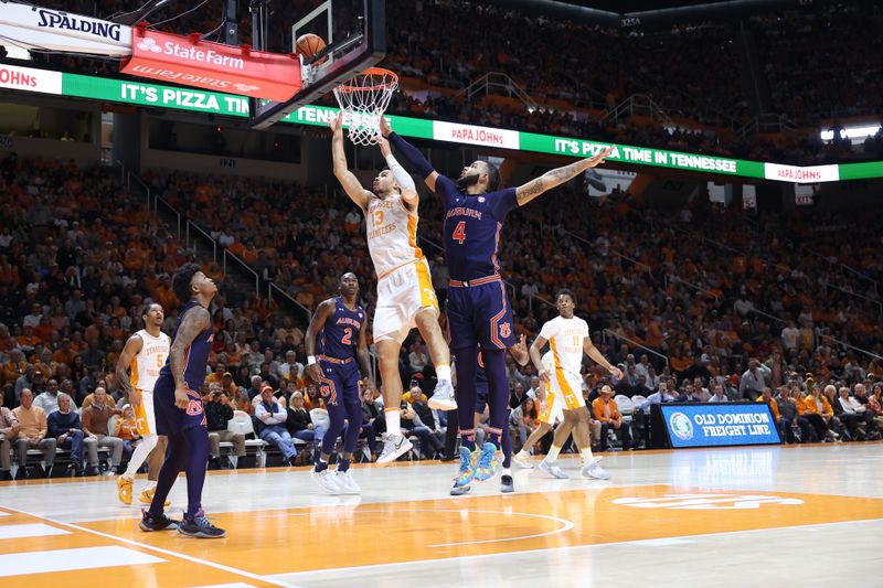 Feb 4, 2023; Knoxville, Tennessee, USA; Tennessee Volunteers forward Olivier Nkamhoua (13) goes to the basket against Auburn Tigers forward Johni Broome (4) during the first half at Thompson-Boling Arena. Mandatory Credit: Randy Sartin-USA TODAY Sports