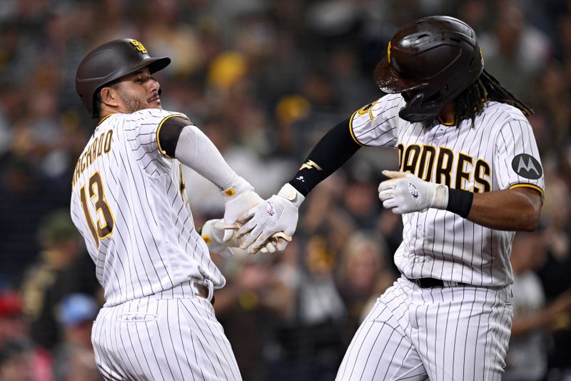 Sep 5, 2023; San Diego, California, USA; San Diego Padres right fielder Fernando Tatis Jr. (right) celebrates with designated hitter Manny Machado (13) after hitting a home run against the Philadelphia Phillies during the fourth inning at Petco Park. Mandatory Credit: Orlando Ramirez-USA TODAY Sports