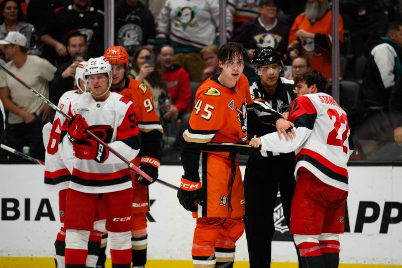 Oct 16, 2025; Anaheim, California, USA; Anaheim Ducks and Carolina Hurricanes players fight after the end of the second period at Honda Center. Mandatory Credit: William Liang-Imagn Images