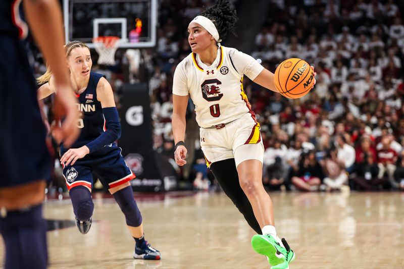 Feb 11, 2024; Columbia, South Carolina, USA; South Carolina Gamecocks guard Te-Hina Paopao (0) drives around UConn Huskies guard Paige Bueckers (5) in the first half at Colonial Life Arena. Mandatory Credit: Jeff Blake-USA TODAY Sports