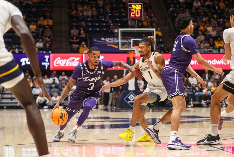 Mar 6, 2024; Morgantown, West Virginia, USA; TCU Horned Frogs guard Avery Anderson III (3) dribbles against West Virginia Mountaineers guard Noah Farrakhan (1) during the first half at WVU Coliseum. Mandatory Credit: Ben Queen-USA TODAY Sports