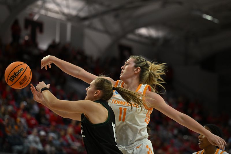 Mar 23, 2024; Raleigh, North Carolina, USA; Tennessee Lady Vols forward Karoline Striplin (11) and Green Bay Phoenix guard Callie Genke (12) reach for a rebound in the first round of the 2024 NCAA Women's Tournament at James T. Valvano Arena at William Neal Reynolds. Mandatory Credit: William Howard-USA TODAY Sports