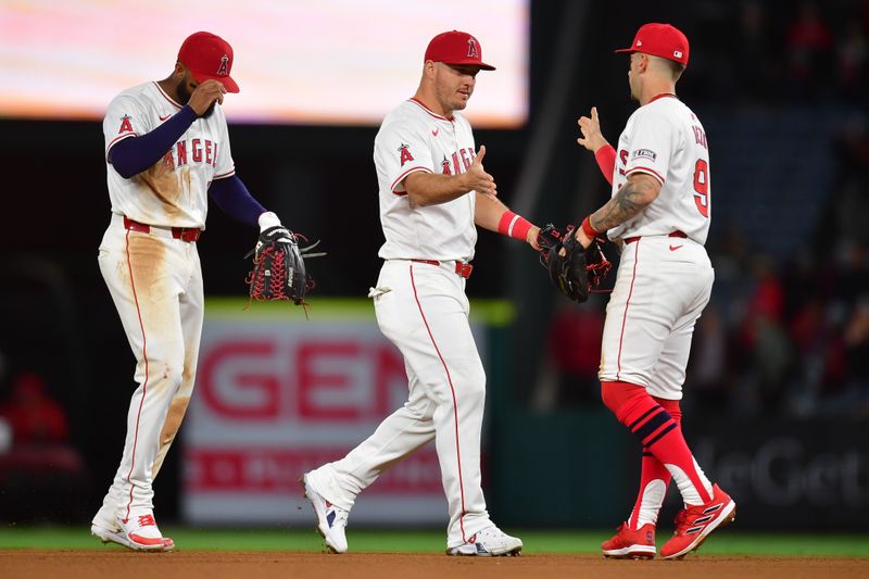 Apr 23, 2024; Anaheim, California, USA; Los Angeles Angels center fielder Mike Trout (27) right fielder Jo Adell (7) and shortstop Zach Neto (9) celebrate the victory against the Baltimore Orioles at Angel Stadium. Mandatory Credit: Gary A. Vasquez-USA TODAY Sports