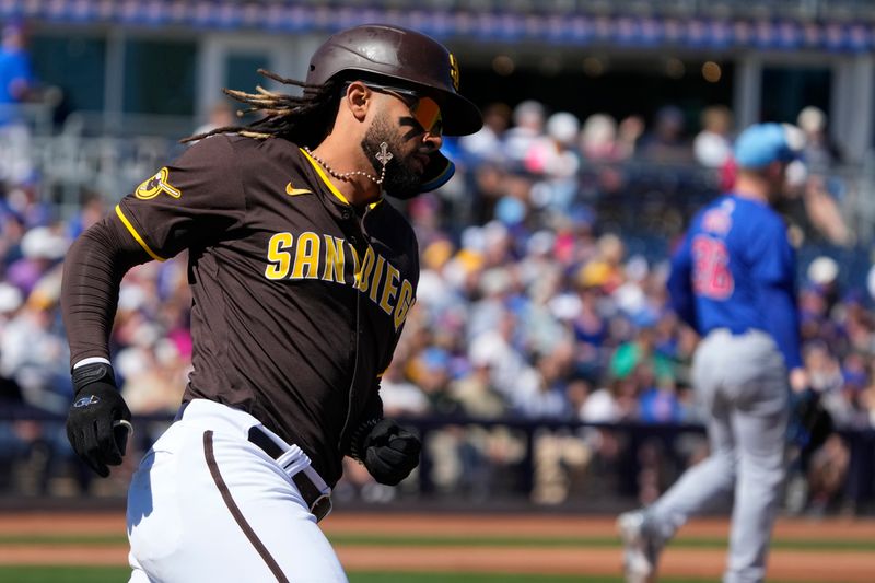 Mar 4, 2024; Peoria, Arizona, USA; San Diego Padres right fielder Fernando Tatis Jr. (23) hits a single against the Chicago Cubs in the first inning at Peoria Sports Complex. Mandatory Credit: Rick Scuteri-USA TODAY Sports