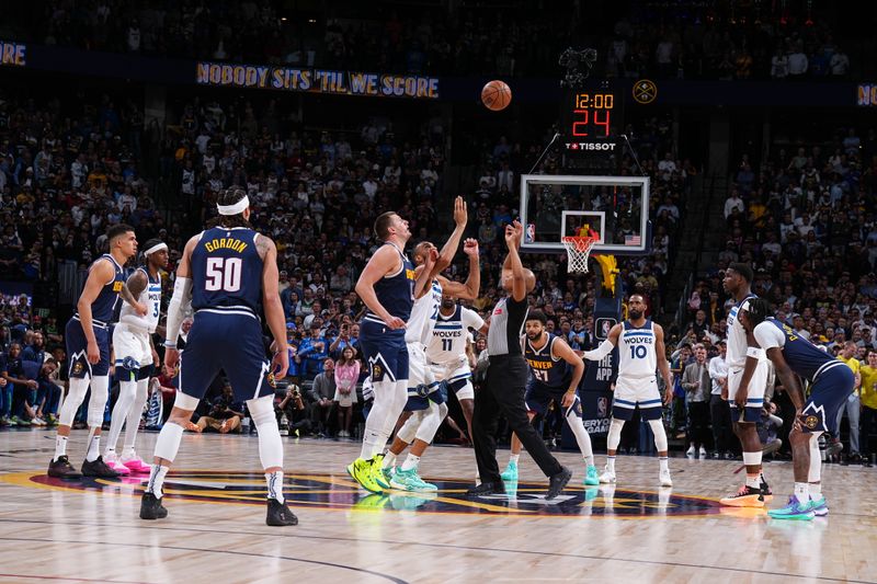 DENVER, CO - APRIL 10: Nikola Jokic #15 of the Denver Nuggets and Rudy Gobert #27 of the Minnesota Timberwolves go up for a jump ball on April 10, 2024 at the Ball Arena in Denver, Colorado. NOTE TO USER: User expressly acknowledges and agrees that, by downloading and/or using this Photograph, user is consenting to the terms and conditions of the Getty Images License Agreement. Mandatory Copyright Notice: Copyright 2024 NBAE (Photo by Garrett Ellwood/NBAE via Getty Images)