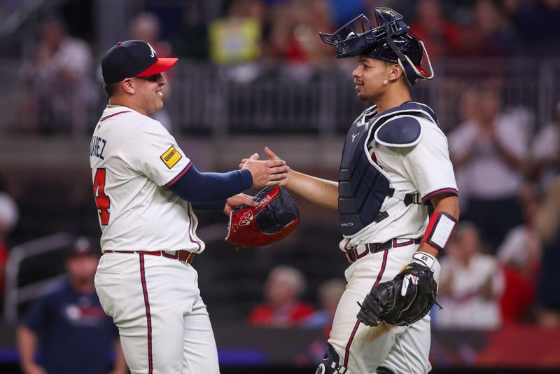 Sep 22, 2025; Atlanta, Georgia, USA; Atlanta Braves relief pitcher Jose Suarez (54) and catcher Drake Baldwin (30) celebrate after a victory over the Washington Nationals at Truist Park. Mandatory Credit: Brett Davis-Imagn Images
