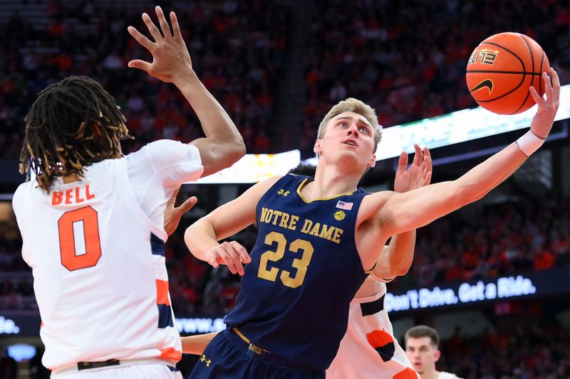 Jan 14, 2023; Syracuse, New York, USA; Notre Dame Fighting Irish guard Dane Goodwin (23) shoots the ball as Syracuse Orange forward Chris Bell (0) defends during the second half at the JMA Wireless Dome. Mandatory Credit: Rich Barnes-USA TODAY Sports