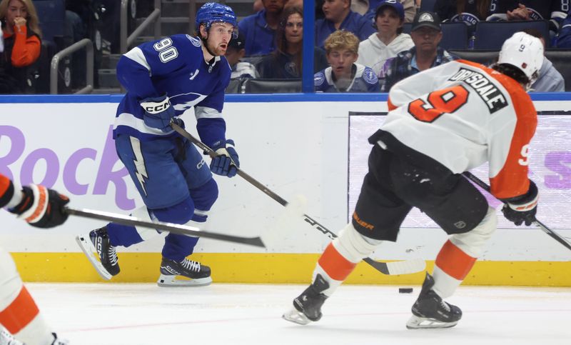 Nov 24, 2025; Tampa, Florida, USA; Tampa Bay Lightning defenseman J.J. Moser (90) skates with the puck as Philadelphia Flyers defenseman Jamie Drysdale (9) defends during the third period at Benchmark International Arena. Mandatory Credit: Kim Klement Neitzel-Imagn Images