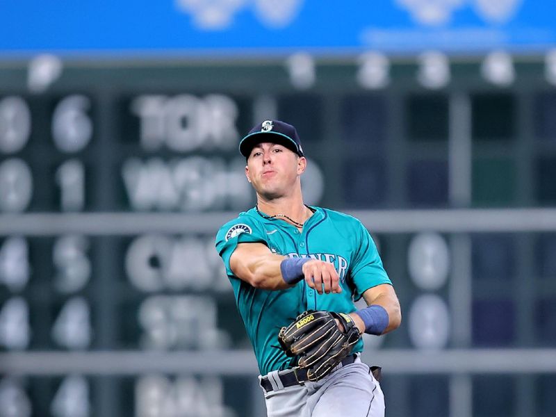 May 5, 2024; Houston, Texas, USA; Seattle Mariners shortstop Dylan Moore (25) throws a fielded ball to first base for an out against the Houston Astros during the third inning at Minute Maid Park. Mandatory Credit: Erik Williams-USA TODAY Sports