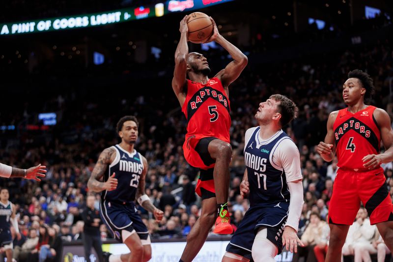 TORONTO, CANADA - FEBRUARY 28: Immanuel Quickley #5 of the Toronto Raptors goes to the net against Luka Doncic #77 of the Dallas Mavericks in the second half of their NBA game at Scotiabank Arena on February 28, 2024 in Toronto, Canada. NOTE TO USER: User expressly acknowledges and agrees that, by downloading and or using this photograph, User is consenting to the terms and conditions of the Getty Images License Agreement. (Photo by Cole Burston/Getty Images)