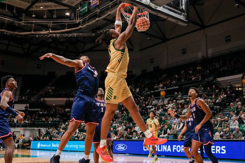 Jan 6, 2024; Charlotte, North Carolina, USA; Charlotte 49ers center Dishon Jackson (1) gets the dunk over Florida Atlantic Owls forward Giancarlo Rosado (3) during the first half at Dale F. Halton Arena. Mandatory Credit: Jim Dedmon-USA TODAY Sports