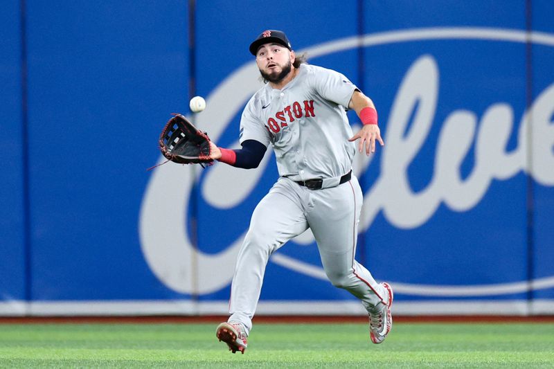 Sep 19, 2024; St. Petersburg, Florida, USA; Boston Red Sox outfielder Wilyer Abreu (52) catches a fly ball against the Tampa Bay Rays in the third inning at Tropicana Field. Mandatory Credit: Nathan Ray Seebeck-Imagn Images