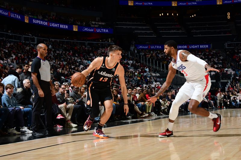 ATLANTA, GA - JANUARY 28: Bogdan Bogdanovic #13 of the Atlanta Hawks handles the ball against defender Paul George #13 of the LA Clippers during the game on January 28, 2023 at State Farm Arena in Atlanta, Georgia.  NOTE TO USER: User expressly acknowledges and agrees that, by downloading and/or using this Photograph, user is consenting to the terms and conditions of the Getty Images License Agreement. Mandatory Copyright Notice: Copyright 2023 NBAE (Photo by Scott Cunningham/NBAE via Getty Images)