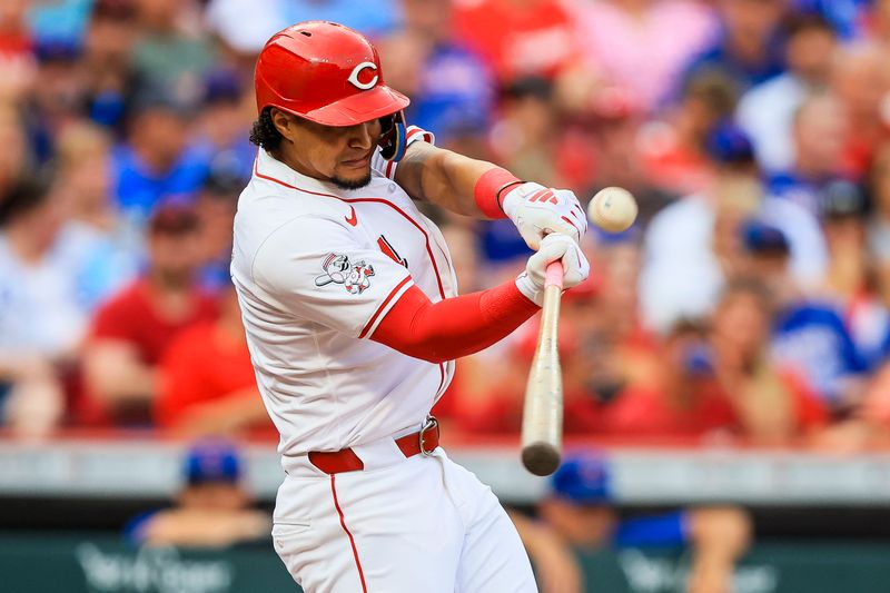 Jul 30, 2024; Cincinnati, Ohio, USA; Cincinnati Reds designated hitter Santiago Espinal (4) hits a two-run home run in the second inning against the Chicago Cubs at Great American Ball Park. Mandatory Credit: Katie Stratman-USA TODAY Sports