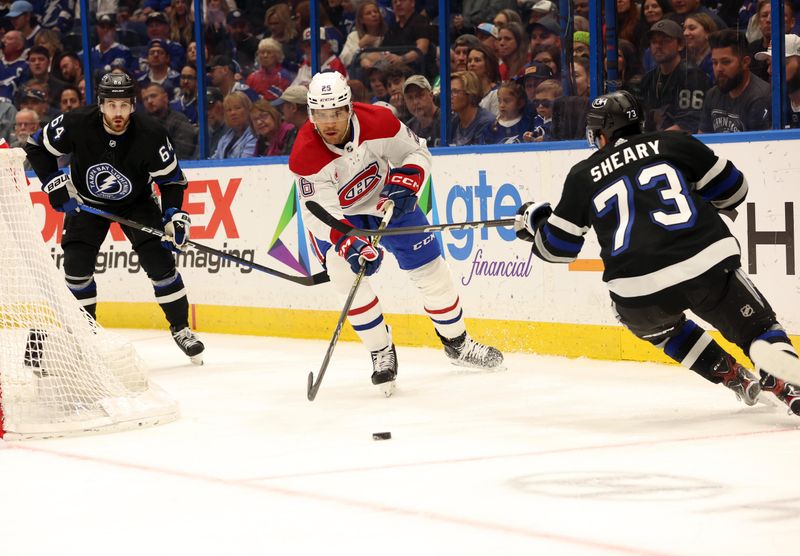 Mar 2, 2024; Tampa, Florida, USA;  Montreal Canadiens defenseman Johnathan Kovacevic (26) skates with the puck as Tampa Bay Lightning left wing Conor Sheary (73) defends during the first period at Amalie Arena. Mandatory Credit: Kim Klement Neitzel-USA TODAY Sports