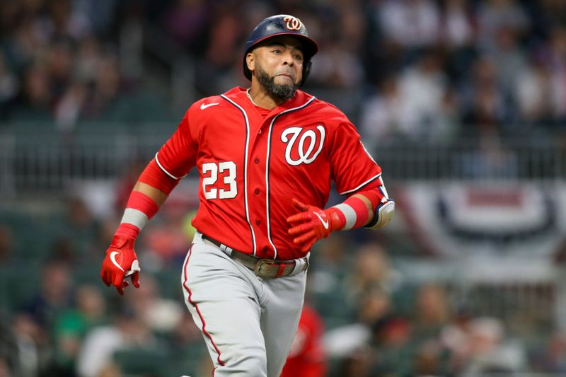 Apr 11, 2022; Atlanta, Georgia, USA; Washington Nationals designated hitter Nelson Cruz (23) hits a single against the Atlanta Braves in the third inning at Truist Park. Mandatory Credit: Brett Davis-USA TODAY Sports