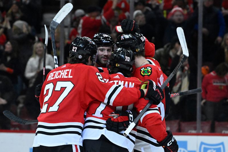 Jan 16, 2024; Chicago, Illinois, USA; Chicago Blackhawks center Cole Guttman (70) celebrates with teammates after scoring a goal against the San Jose Sharks during the first period at United Center. Mandatory Credit: Matt Marton-USA TODAY Sports