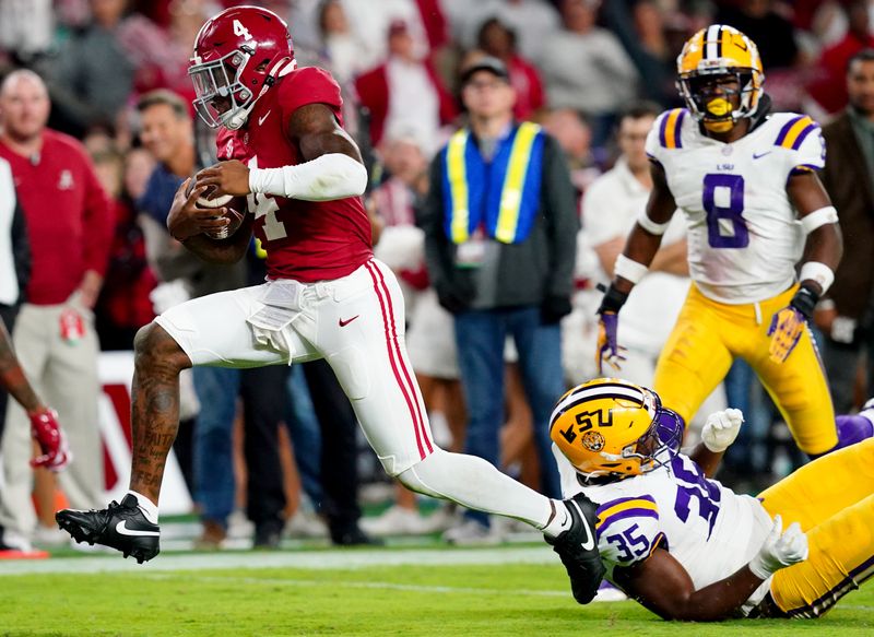 Nov 4, 2023; Tuscaloosa, Alabama, USA; Alabama Crimson Tide quarterback Jalen Milroe (4) scrambles up the field against LSU Tigers defensive end Saivion Jones (35) during the second half at Bryant-Denny Stadium. Alabama Crimson Tide defeated the LSU Tigers 42-28. Mandatory Credit: John David Mercer-USA TODAY Sports