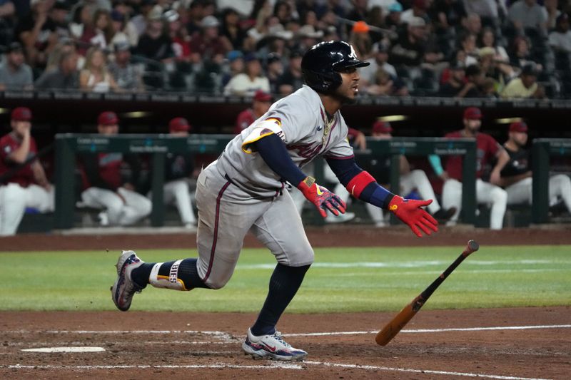Apr 25, 2025; Phoenix, Arizona, USA; Atlanta Braves second base Ozzie Albies (1) hits an RBI double against the Arizona Diamondbacks in the eighth inning at Chase Field. Mandatory Credit: Rick Scuteri-Imagn Images