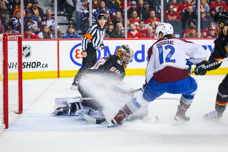 Mar 12, 2024; Calgary, Alberta, CAN; Calgary Flames goaltender Dan Vladar (80) makes a save against Colorado Avalanche right wing Brandon Duhaime (12) during the first period at Scotiabank Saddledome. Mandatory Credit: Sergei Belski-USA TODAY Sports