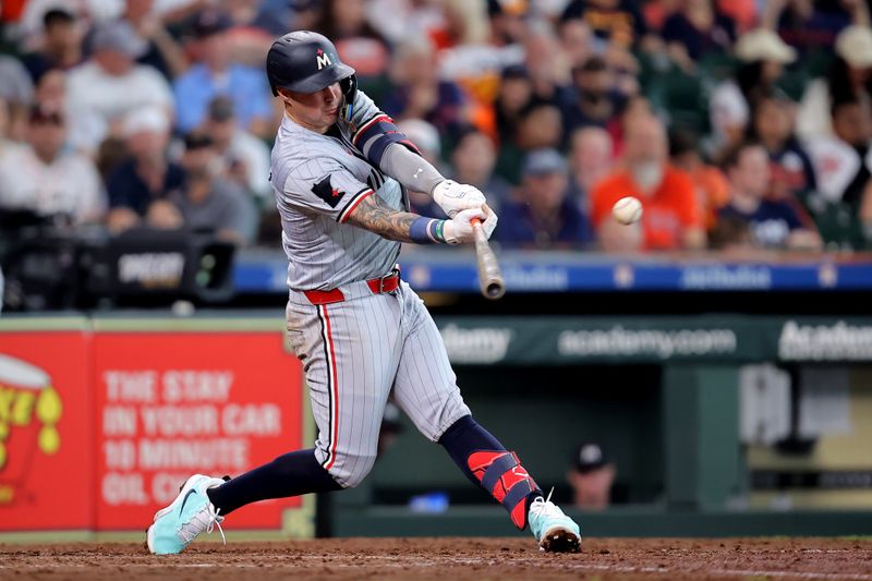 Jun 1, 2024; Houston, Texas, USA; Minnesota Twins third baseman Jose Miranda (64) hits an RBI single against the Houston Astros during the seventh inning at Minute Maid Park. Mandatory Credit: Erik Williams-USA TODAY Sports