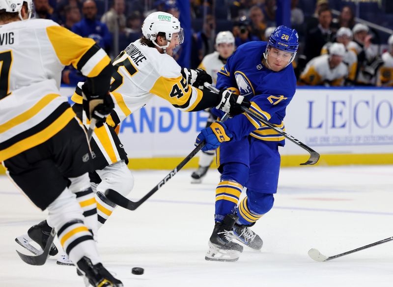 Sep 21, 2024; Buffalo, New York, USA;  Pittsburgh Penguins defenseman Harrison Brunicke (45) tries to block a shot by Buffalo Sabres center Jiri Kulich (20) during the second period at KeyBank Center. Mandatory Credit: Timothy T. Ludwig-Imagn Images